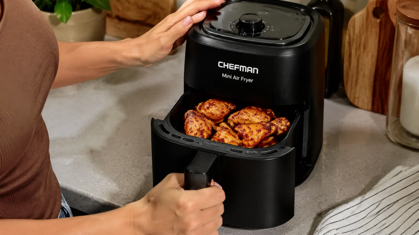 CHEFMAN 2 Qt air fryer basket pulled open showing a single serving of chicken wings